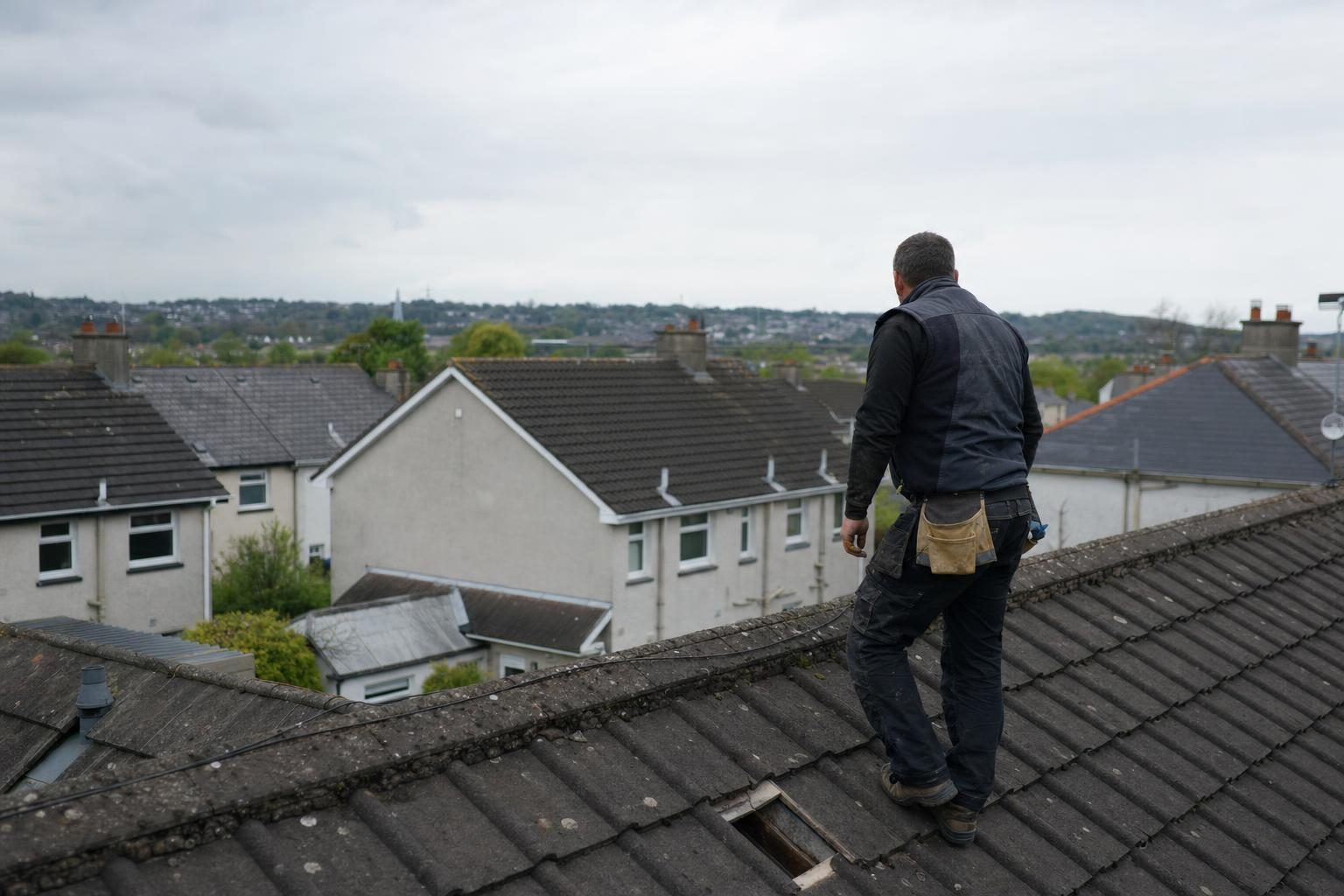 Roofer on a Limerick rooftop ready to assess a repair job